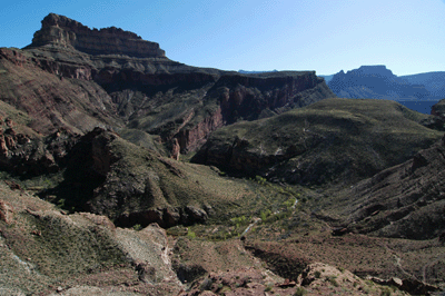 Descending the High Bypass to Shinumo Creek with Dox Castle (left) and Tyndall Dome (right in far background) visible in the distance